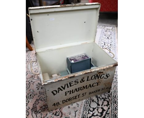 A vintage painted tin first-aid 'Dressings' box from Davies &amp; Long's Pharmacy, Baker St (London), containing various band
