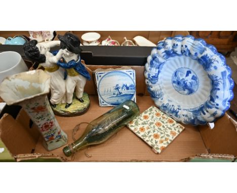 An antique Delft blue and white tile depicting a milkmaid to/w a 20th century Delft wall-plate with scalloped rim, early 19th