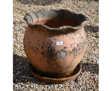 A weathered terracotta planter (40 cm high x 42 cm diameter) and circular tray (2) 