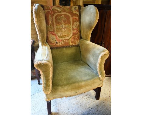 An antique mahogany framed wingback armchair on square legs (f/r) 