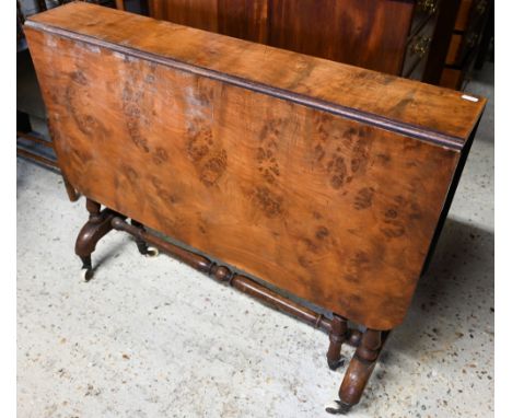 A Victorian figured walnut Sutherland table, raised on twin turned ends, on white ceramic castors, 90 cm x 18 cm x 73 cm h 