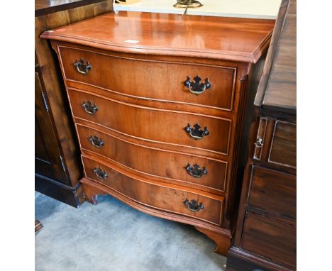 A reproduction yew serpentine chest of four long drawers, raised on shaped bracket feet
