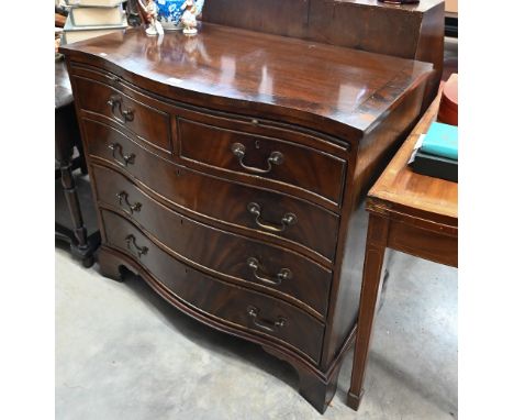 A Georgian style mahogany serpentine front chest with brush slide over two short and three long drawers raised on bracket fee