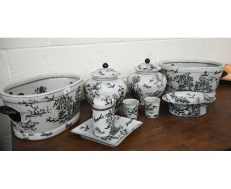 A suite of chinoiserie monochrome-printed ceramic wares including two plant troughs, two globular pots and covers, two jars, 
