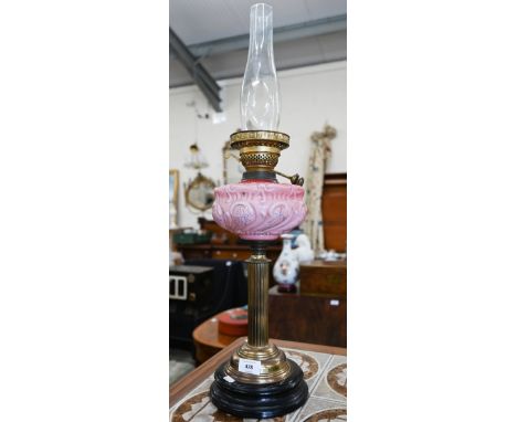 A brass-pillar oil lamp with pink glass font 
