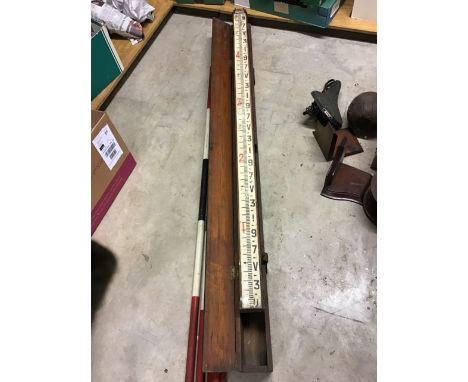 A collection of early 20th century surveyors tools, poles etc. 
