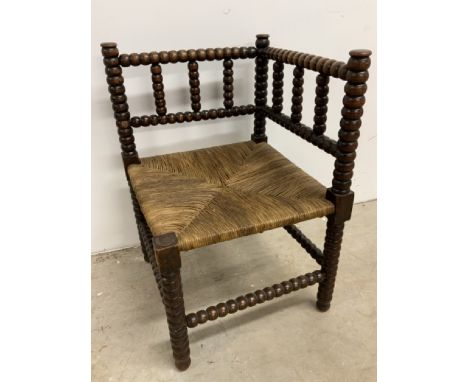 An antique bobbin turned corner chair with wicker seatW:41cm x D:41cm x H:62cm