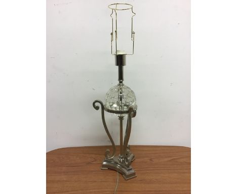 A modern white metal lamp with central moulded glass sphere. 60cm (h)