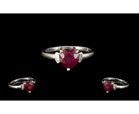 Ruby and Diamond Heart Shape Ring, a heart cut warm red ruby of 2.5cts, set as a solitaire, flanked by baguette cut accent di