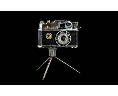 KKP Photo Flash Cigarette Lighter in the form of a camera, mounted.
