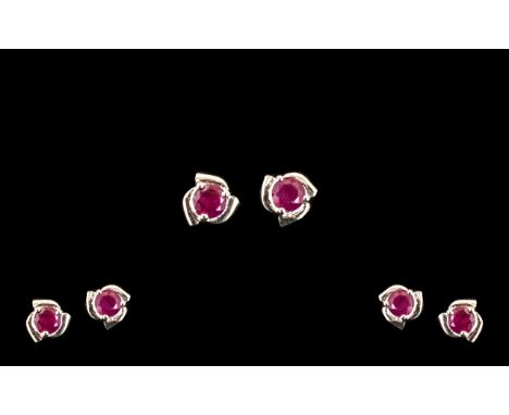 Ruby Solitaire Stud Earrings, round cut solitaire rubies totalling 1ct, each set in a three part sweeping silver frame; a sim
