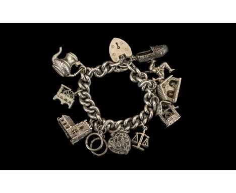 A Sterling Silver Charm Bracelet Loaded with 11 Good Quality Old Charms. Both Bracelet and Charms Marked for Sterling Silver.