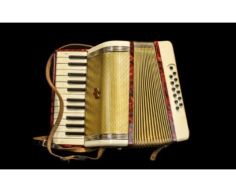 Vintage Accordion by Kitchen's of Leeds in mock crocodile style case in brown, complete with loose music sheets.  In working 