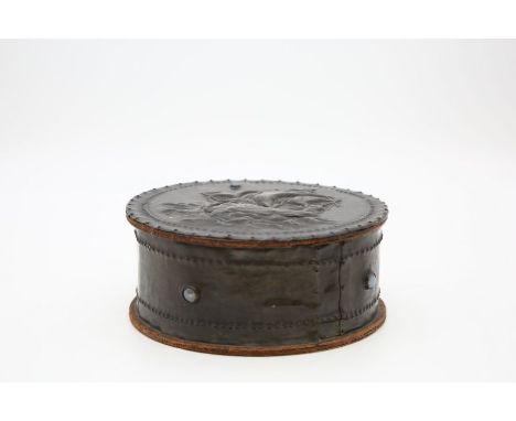 An&nbsp; Arts and Crafts style circular box and cover, the lid in relief with a ship at sea, applied opaline glass cabachons,