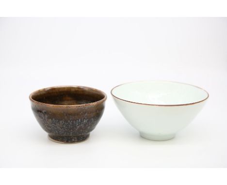 2 Derek Emms bowls. One with light celadon glaze and incised decoration to the inside and the second with a brown tenmoku gla