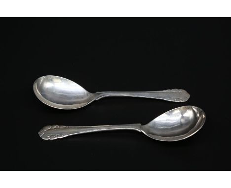A matched pair of George Jensen large silver 'Rose' pattern spoons. Both have George Jensen hallmarks for 1915 to 1930 and on