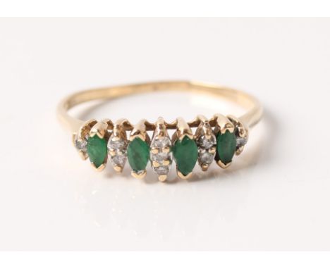 An emerald and diamond ring, set with four marquise cut emeralds, separated by round cut diamond accents set into marquise sh