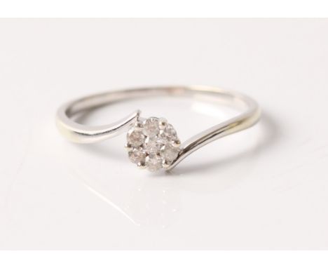 A hallmarked 9ct white gold diamond flower head cluster ring, total diamond weight approx. 0.14ct, ring size P