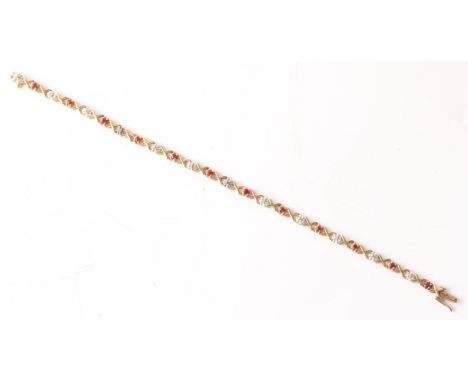 A hallmarked 9ct yellow gold ruby and diamond bracelet, set alternately with round cut rubies and round cut diamond accents, 