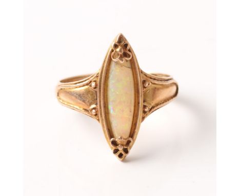 An opal ring, set with a marquise shaped opal cabochon with decorative floral metalwork to either end, unmarked rose metal, r