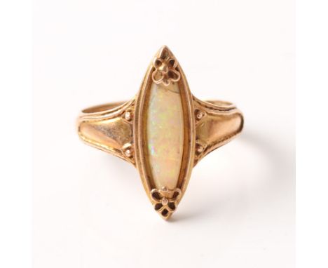 An opal ring, set with a marquise shaped opal cabochon with decorative floral metalwork to either end, unmarked rose metal, r