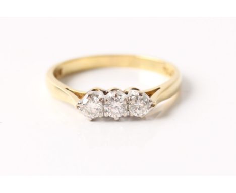 A hallmarked 18ct three stone diamond ring, set with three round brilliant cut diamonds, total diamond weight approx. 0.30ct,