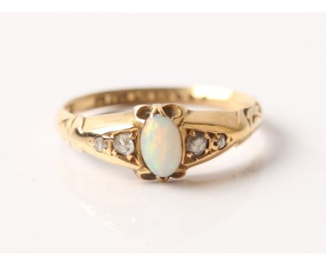 A hallmarked 18ct yellow gold opal and diamond ring, set with a central oval opal cabochon flanked to either side with two di