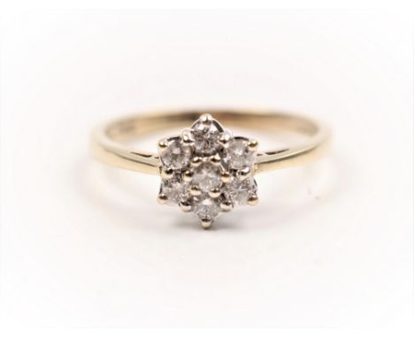 A hallmarked 9ct yellow gold diamond cluster ring, set with seven round brilliant cut diamonds in flower head design, total d