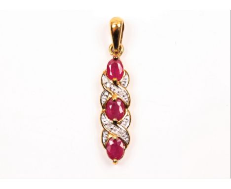 A hallmarked 9ct yellow gold ruby and diamond pendant, set with three oval cut rubies separated by single-cut diamond accents