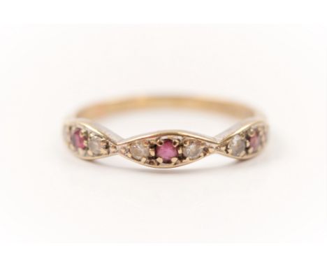 A hallmarked 9ct yellow gold ruby and cubic zirconia half eternity ring, ring size O