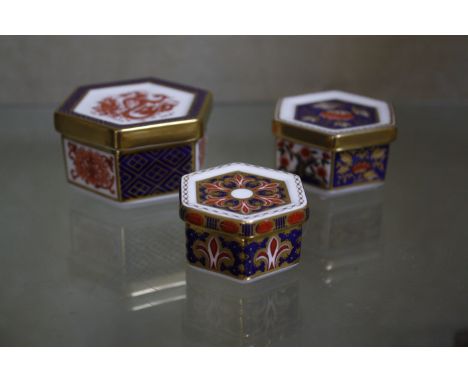 Three Royal Crown Derby hexagonal trinket boxes (A 1297 4cm wide, A 1295 5.5cm wide, A 1298, 5cm wide) 