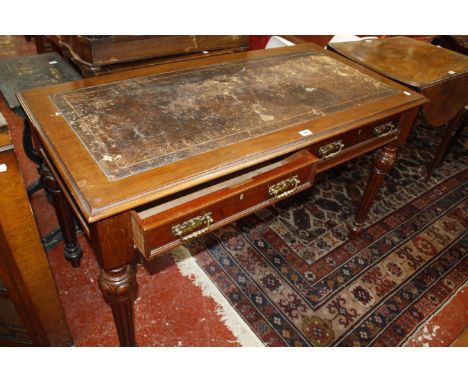 A Victorian mahogany writing desk, with an inset writing surface, both drawers bearing stamp J.A SHOOLBRED & Co on bulbous an