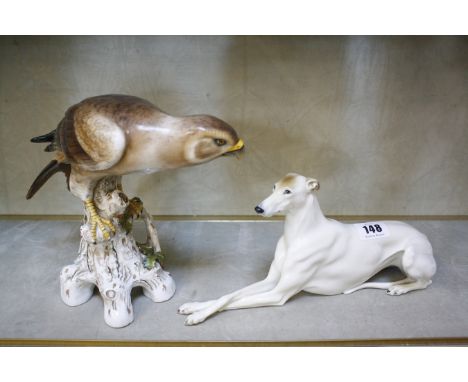 A Capodimonte model of a hawk, 18cm high and a porcelain hound (damaged) (2) 