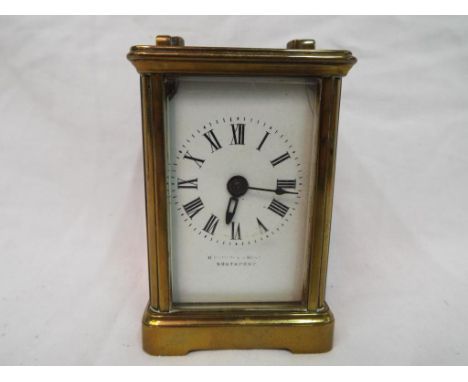 A brass carriage clock, Roman numerals to a white dial, movement marked 'R &amp; Co Made in Paris', retailed by H Pidduck &am