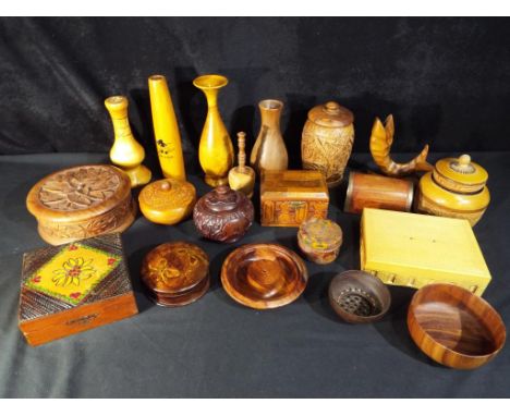 A quantity of treen to include trinket boxes, vases, lidded jars and similar.