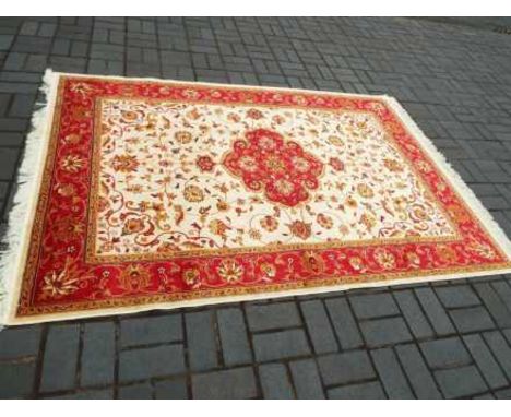 A Keshan carpet with a beige ground, approx 230cm x 160cm  UNUSED