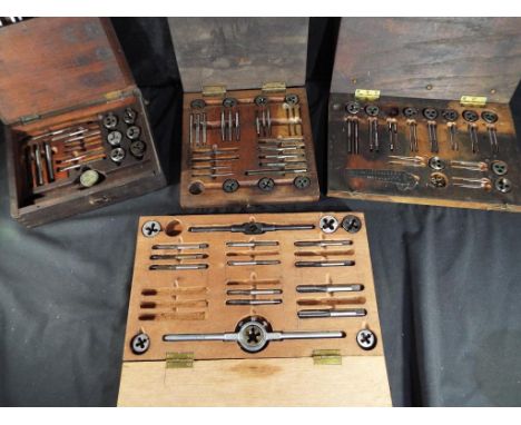 Four wooden cases, containing a quantity of watchmaker's tools.