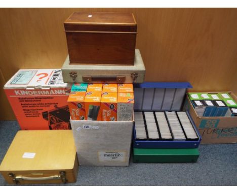 A Kindermann auto focus slide projector contained in original box and a large quantity of photographic slides (3)