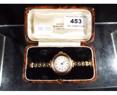 A lady's wristwatch with ceramic dial and rolled gold strap, dial approximately 1.8 cm