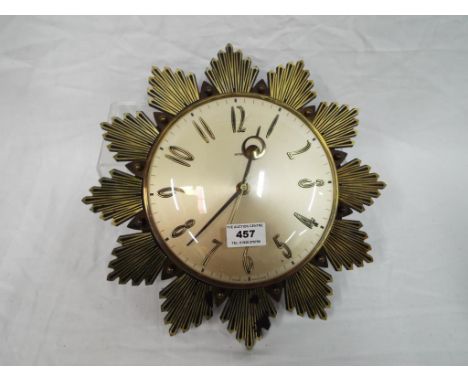 Metamec - a 20th century retro vintage sunburst starburst wall clock having Arabic and baton numeral chapter ring and faceted
