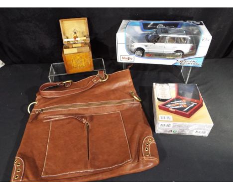 A mixed lot to include unused brown leather bag, unused boxed bartender's set, vintage wooden cigarette dispenser and a Maist