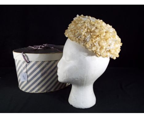 Christian Dior - a 1960s Christian Dior Licence Chapeaux flower hat, with internal net and hair slide grip with Christian Dio