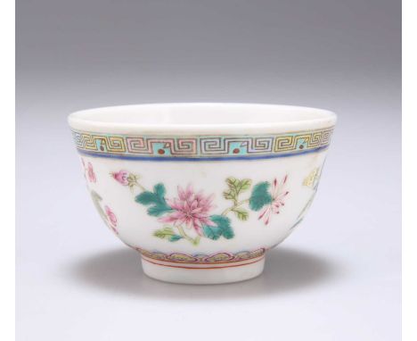 A CHINESE FAMILLE ROSE WINE CUP enamel painted with floral sprays, bears underglaze blue six character mark. 7cm diameter