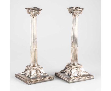 A PAIR OF GEORGE III SILVER COLUMNAR CANDLESTICKS possibly by William Watkins, London 1772, each with stop-fluted Ionic colum