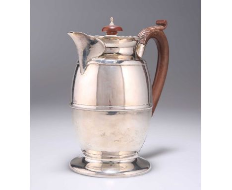 A GEORGE V SILVER HOT WATER JUG maker's mark indistinct, Birmingham 1929, barrel-shaped, the handle with leaf-form thumbpiece