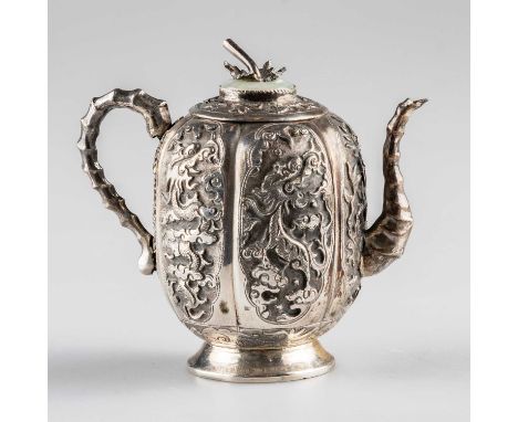 A CHINESE SILVER AND JADE TEAPOT of small proportions, chased with dragons, phoenix and foliage, stamped 70% SILVER. 8cm high