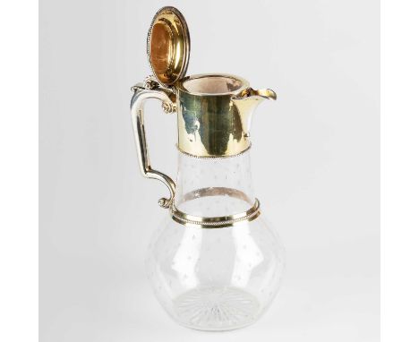 A VICTORIAN SILVER GILT-MOUNTED GLASS CLARET JUG by John Wilmin Figg, London 1867, the hinged cover with beaded rim and scrol