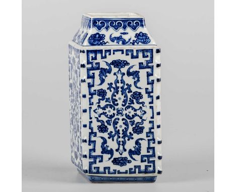 A CHINESE BLUE AND WHITE RHOMBOID VASE painted with bats and foliage within key pattern borders, with stepped base and moulde