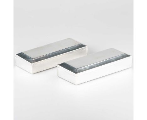 A PAIR OF AMERICAN STERLING SILVER CIGARETTE BOXES by Gorham, each rectangular with hinged cover, wood lined. (2) 19.5cm long