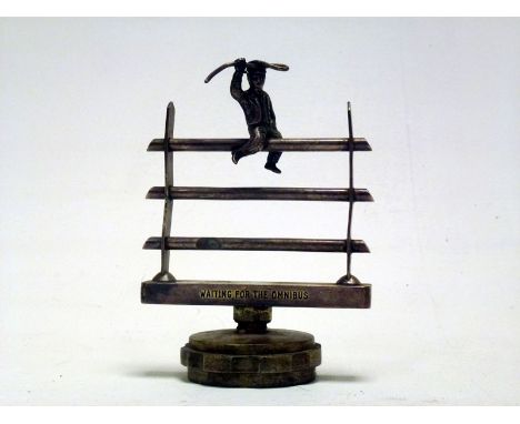 Very unusual mascot featuring a country yokel in suit and peaked cap holding a whip and seated on top rung of a three bar fen